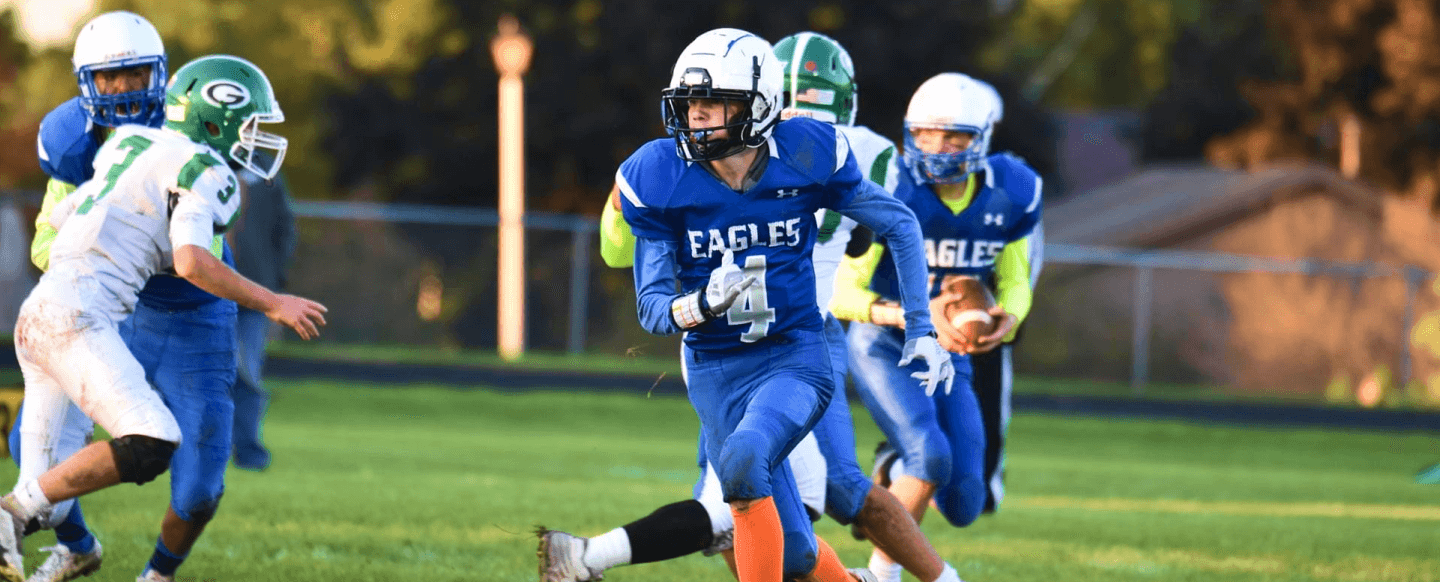 Football player running with football