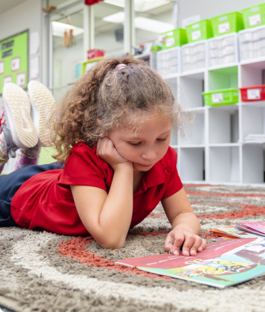 Girl reading on rug