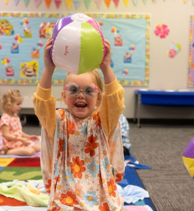 Girls playing with a beach ball in class