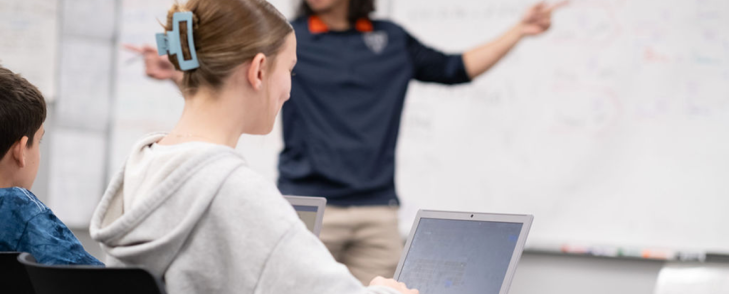 High School girl studying with laptop in class