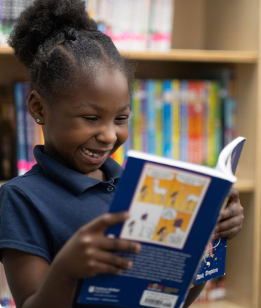 Smiling Girl Reading a Book