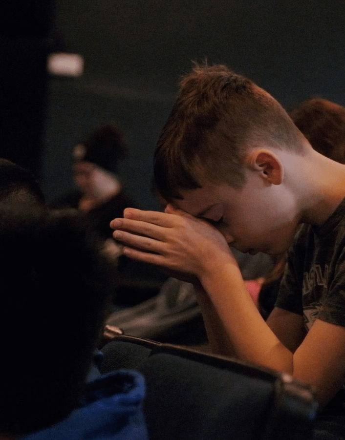 Young boy praying in chapel