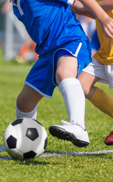 Student kicking a soccer ball